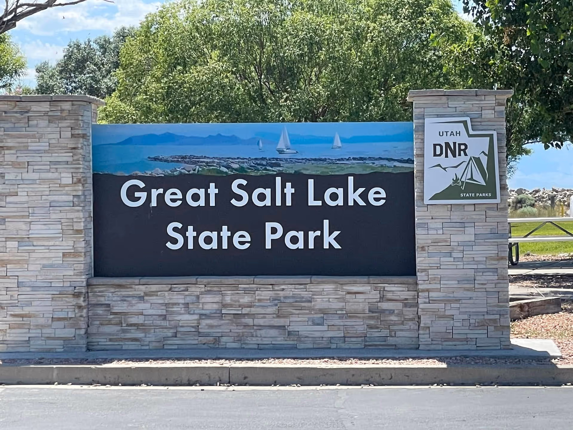 Stone sign reads Great Salt Lake State Park with Utah DNR plaque at entrance.