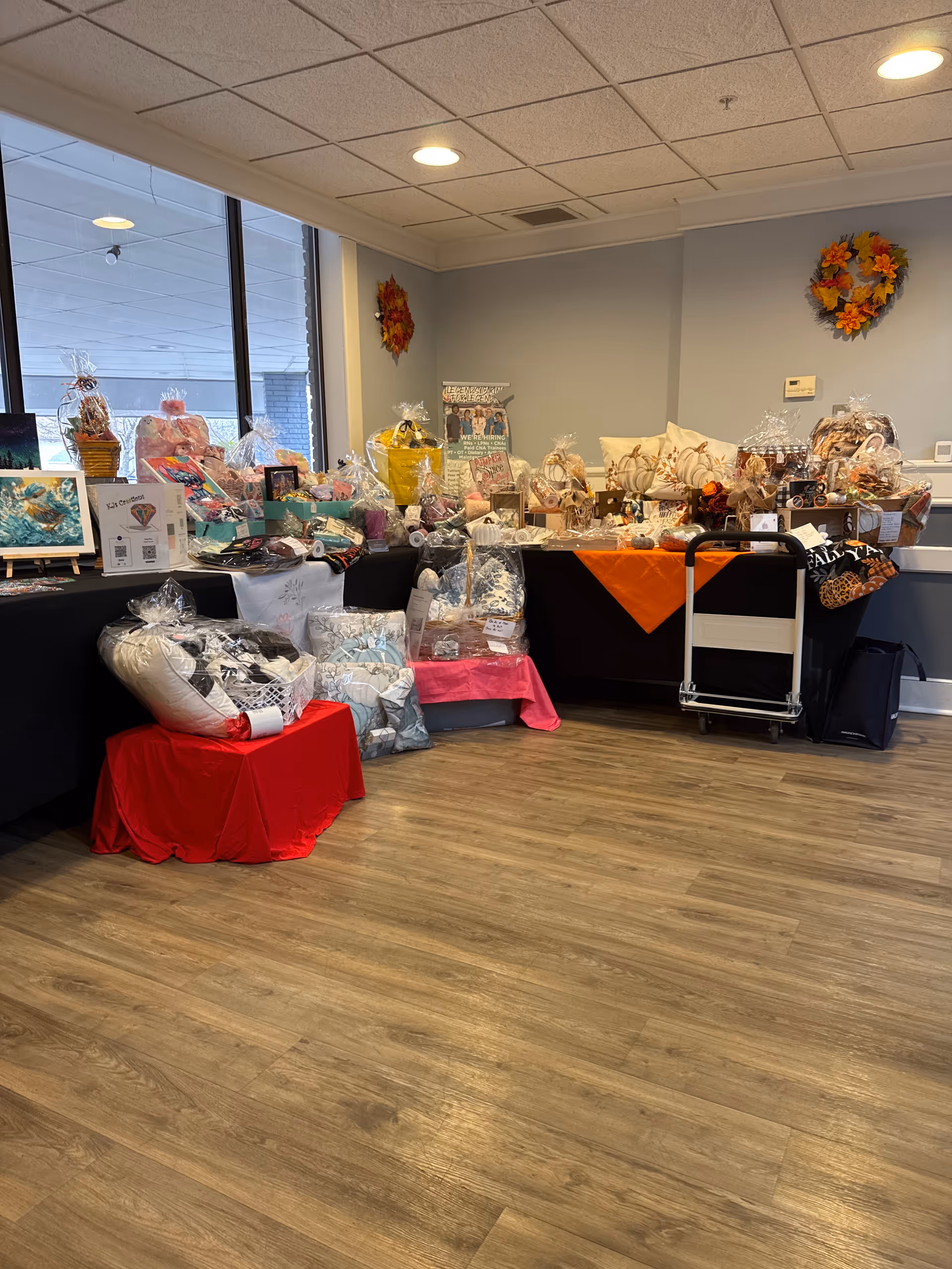 Gift baskets and items arranged on tables in a bright interior room.