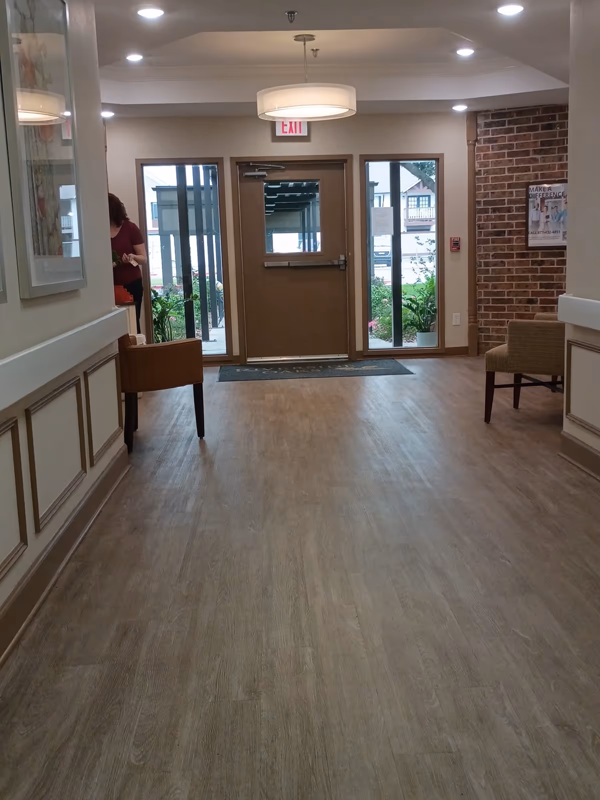 Indoor lobby at Retama Manor Nursing Center Victoria South with exit doors and seating.