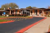 Knox County Nursing Home exterior: single-story brick building with large windows and parking.