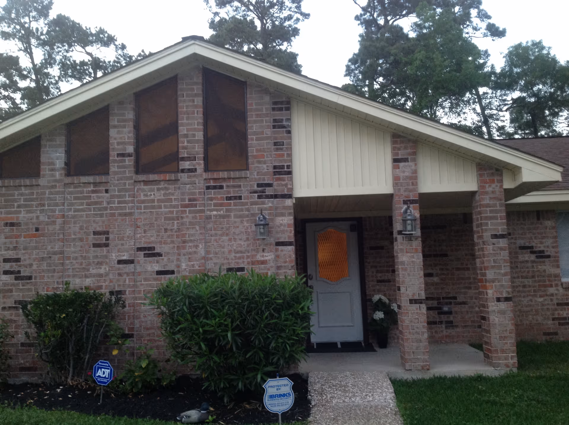 Front view of a brick assisted living facility entrance with a covered porch.