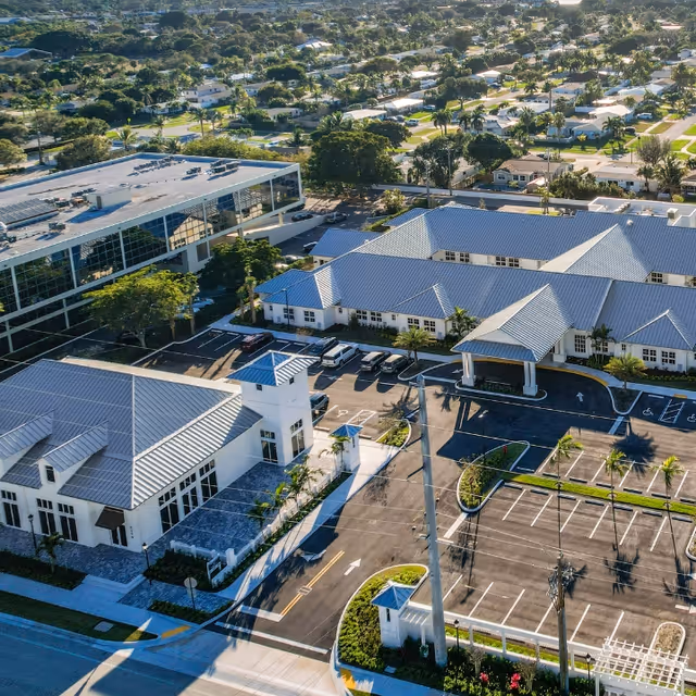 Aerial view of Alta Senior Living campus with blue roofs and parking lots.