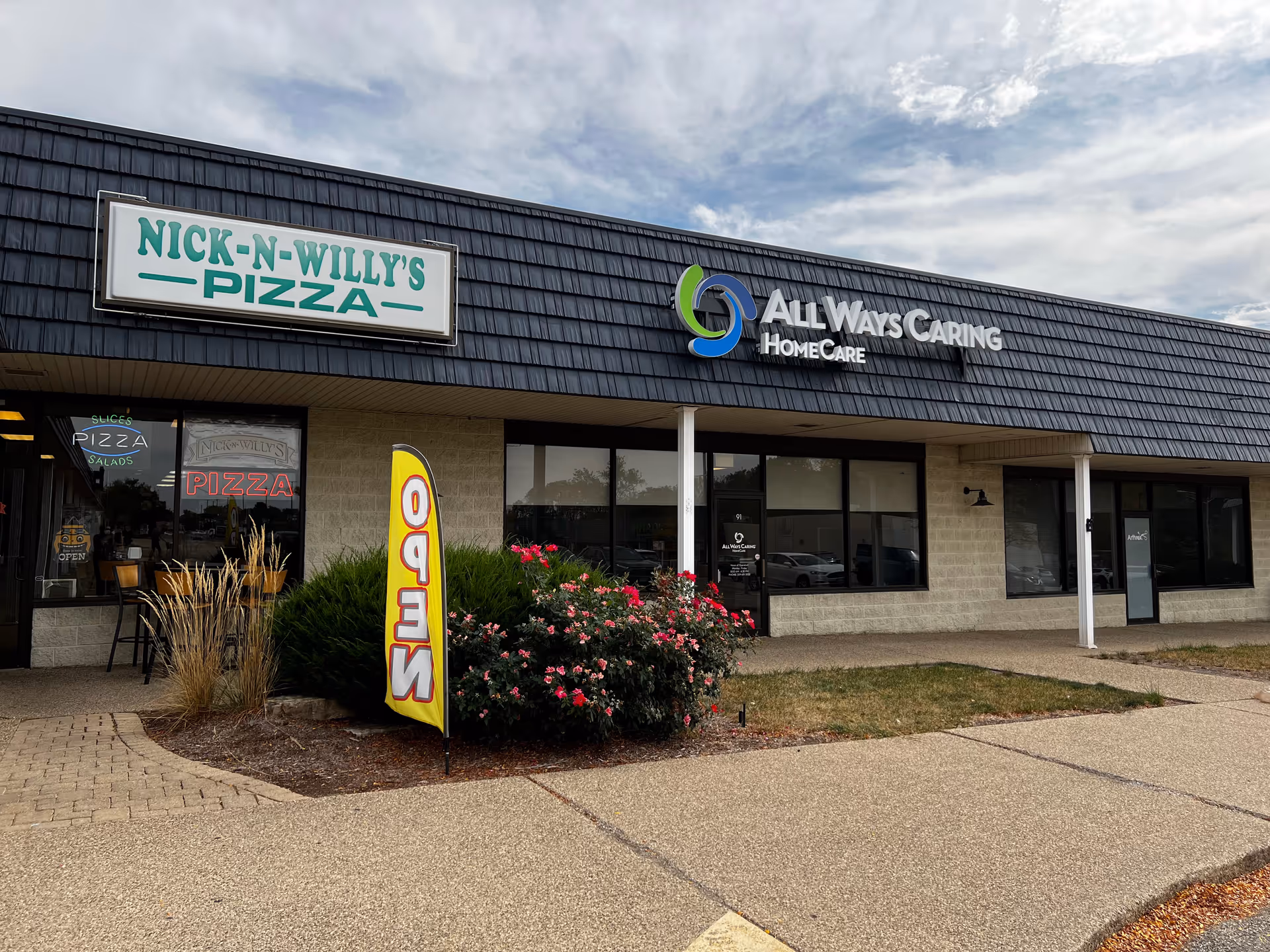 Exterior view of a strip storefront with All Ways Caring HomeCare signage in Peoria, Illinois.