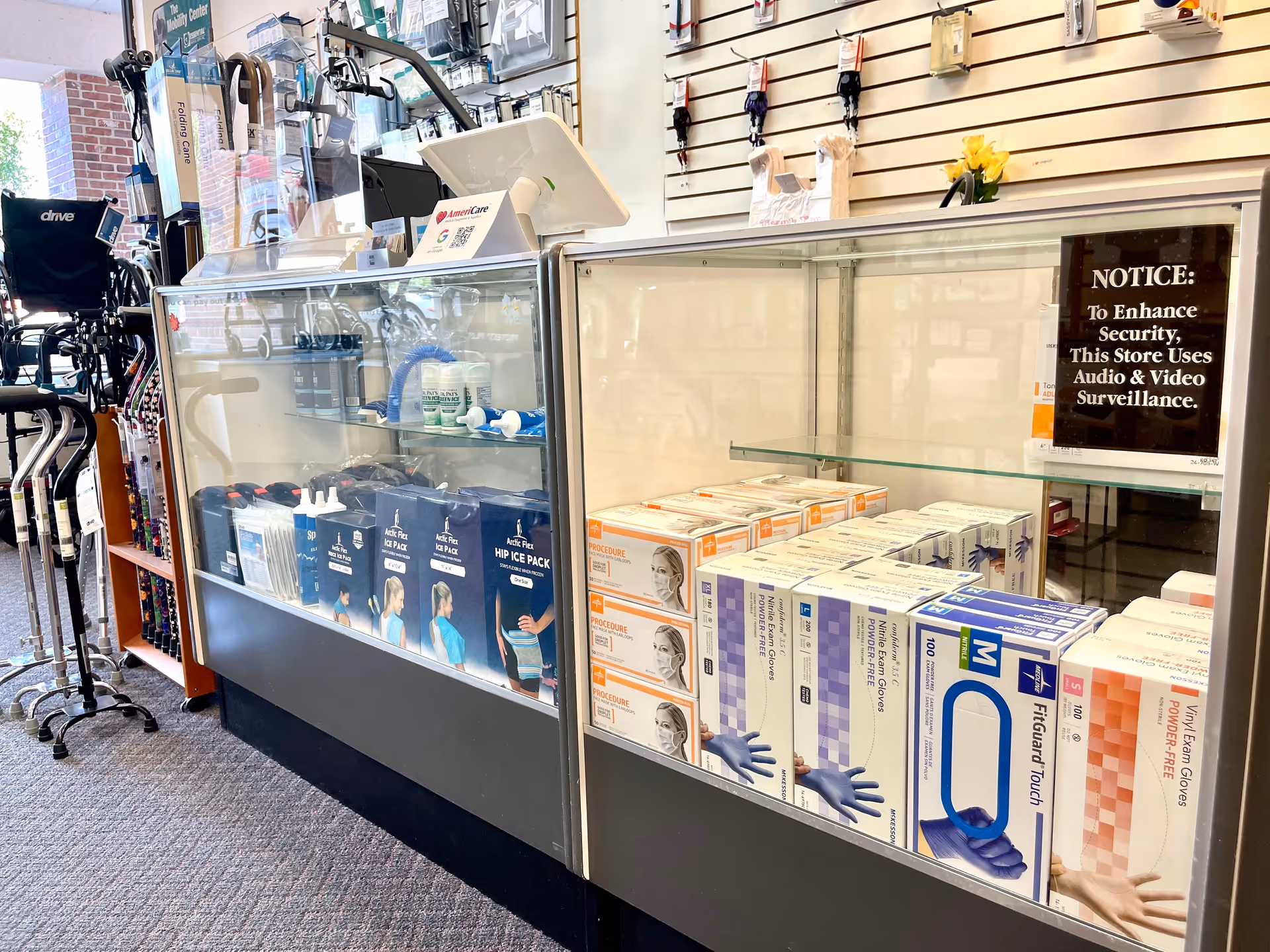 Interior of Americare Medical Supplies and Services store with glass display cases and boxed medical products.