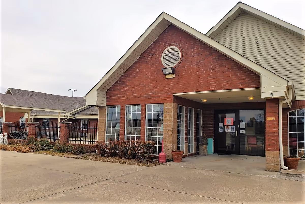 Beare Manor senior living facility building exterior with brick facade and glass entrance.