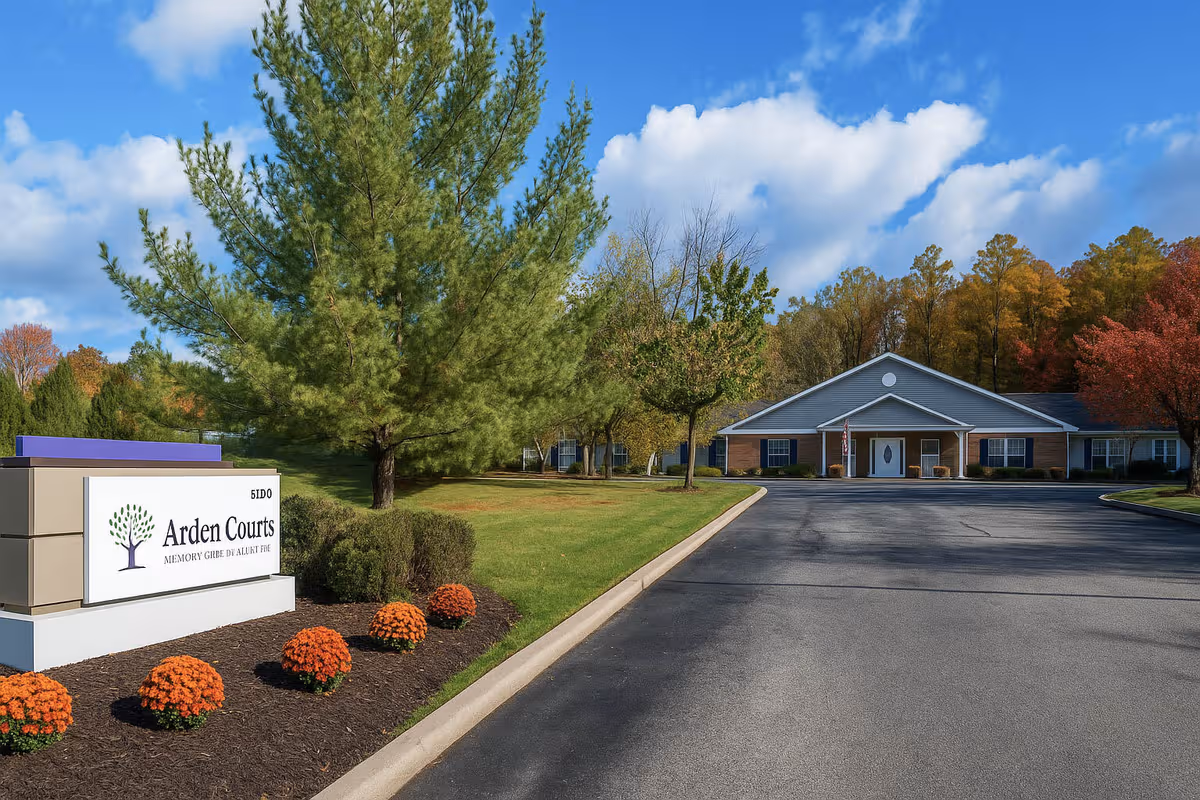 Front view of Arden Courts Chagrin Falls with driveway, sign, and trees.