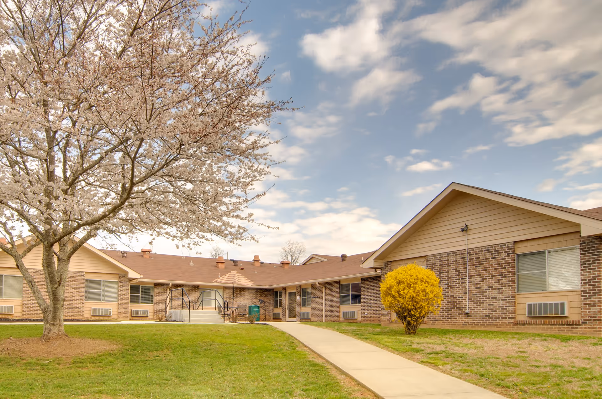 Exterior of Life Care Center of Copper Basin, a one-story brick building with a curved walkway.