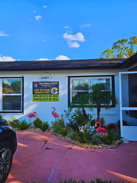 Front exterior of Santa Susana ALF Inc with plants and flamingo decorations.