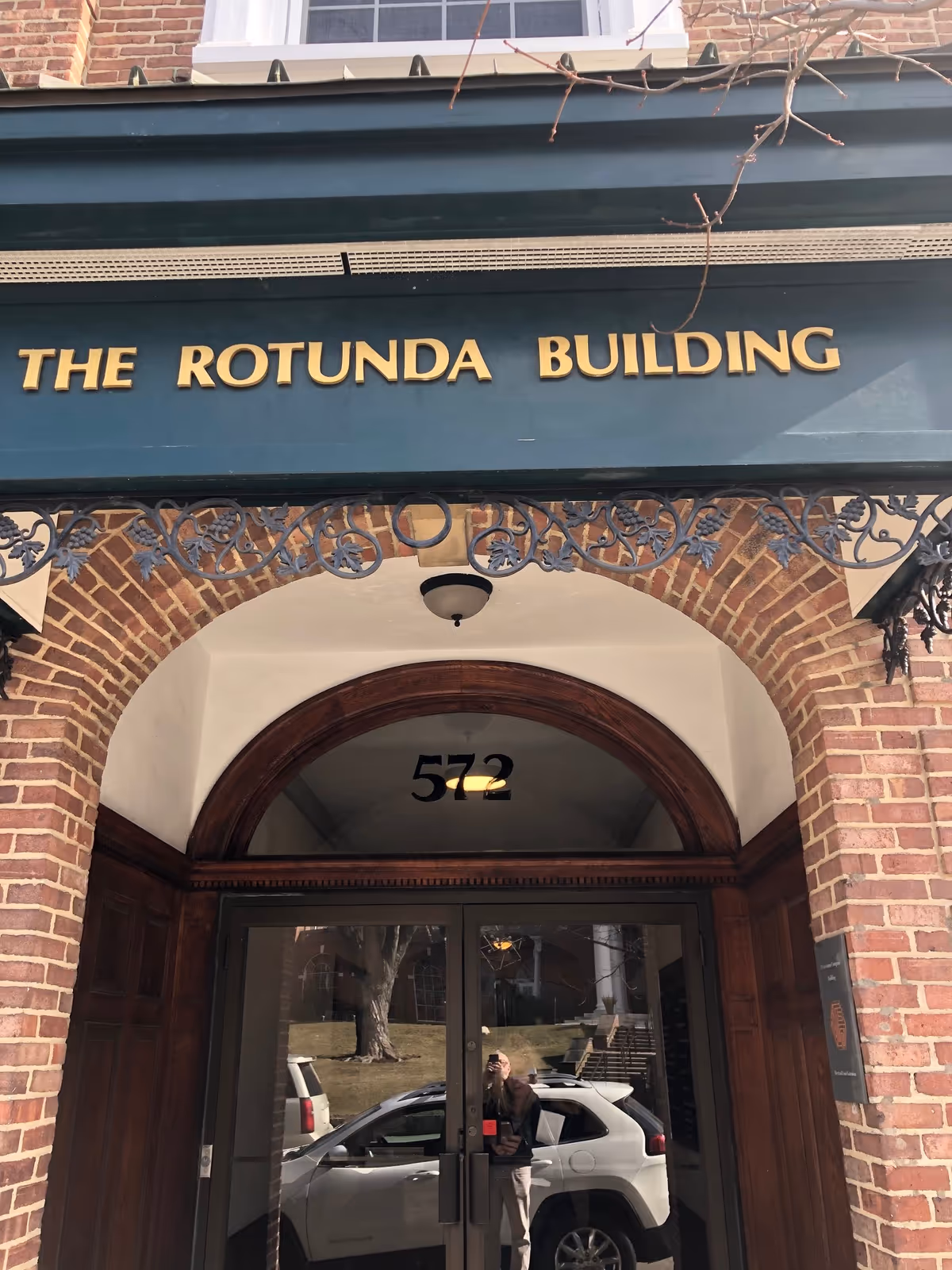Brick building entrance with arched doorway and gold lettering 'THE ROTUNDA BUILDING'.
