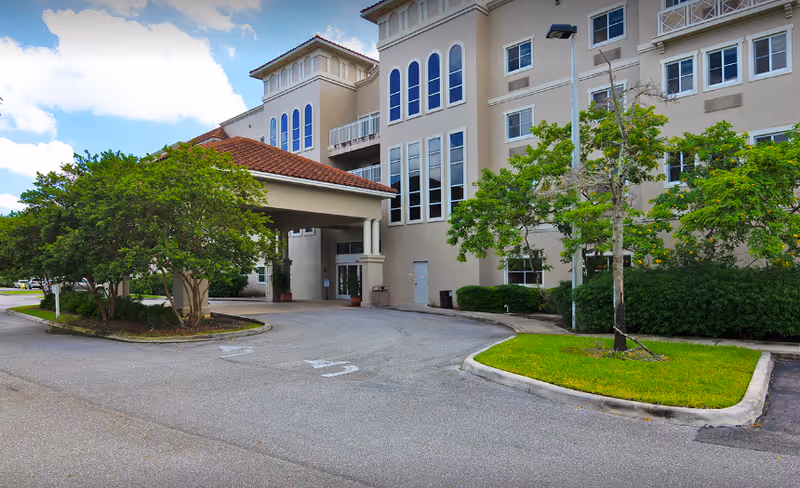 Exterior view of Lenox on the Lake facility entrance with drive and landscaping