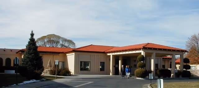 Exterior view of La Villa Grande Care Center with a red-tile roof and entrance canopy.