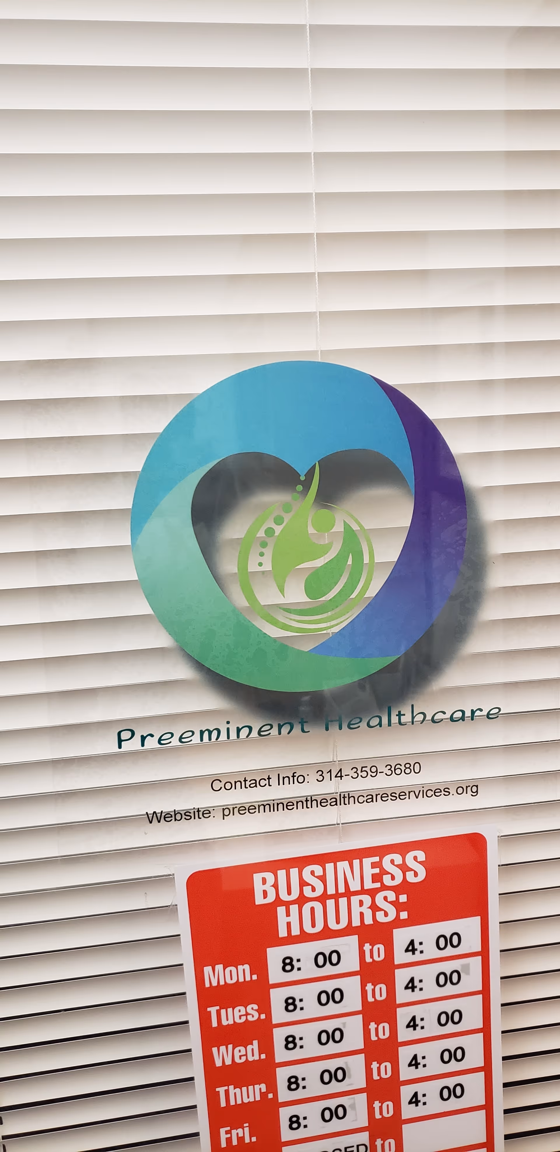 Sign for Preeminent Healthcare with hours displayed on window blinds.