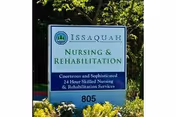 Outdoor sign reads Issaquah Nursing & Rehabilitation with landscaping nearby.