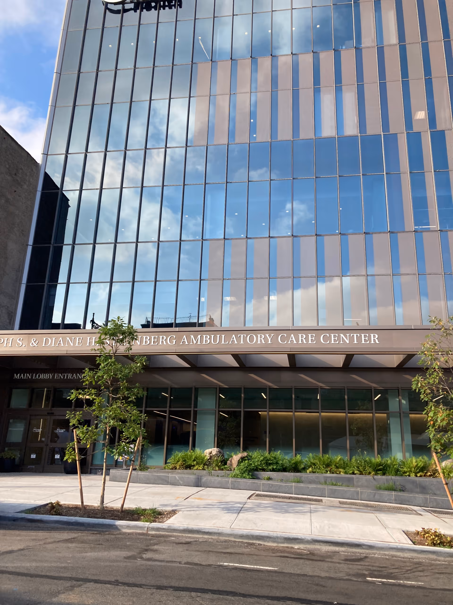 Exterior of a glass-front building with a sign for the Steinberg Ambulatory Care Center.