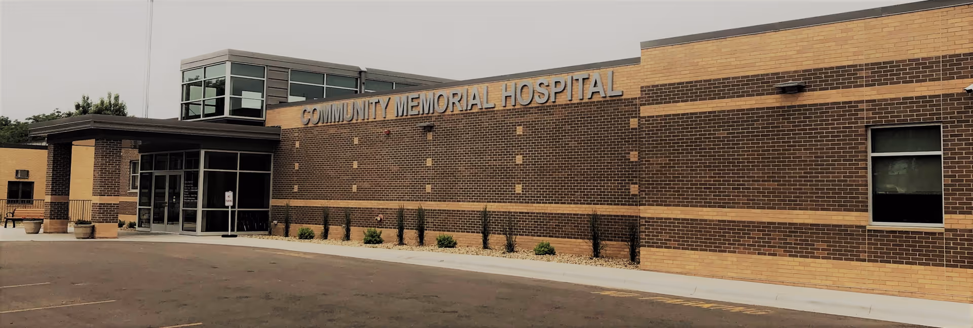Exterior view of Community Memorial Hospital building with entrance and landscaping.