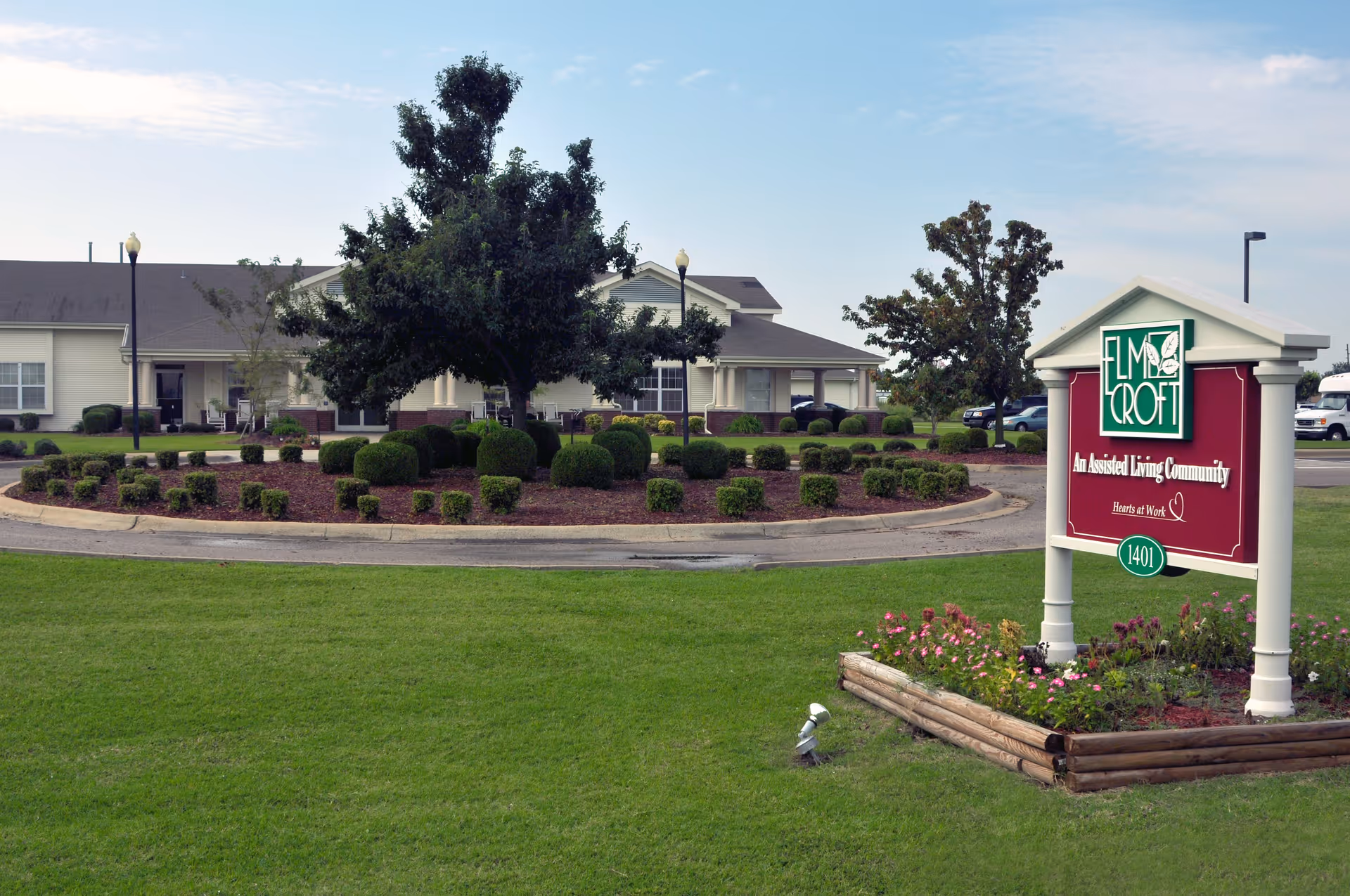 Exterior view of StoneBridge Senior Living Blytheville with landscaped roundabout and sign