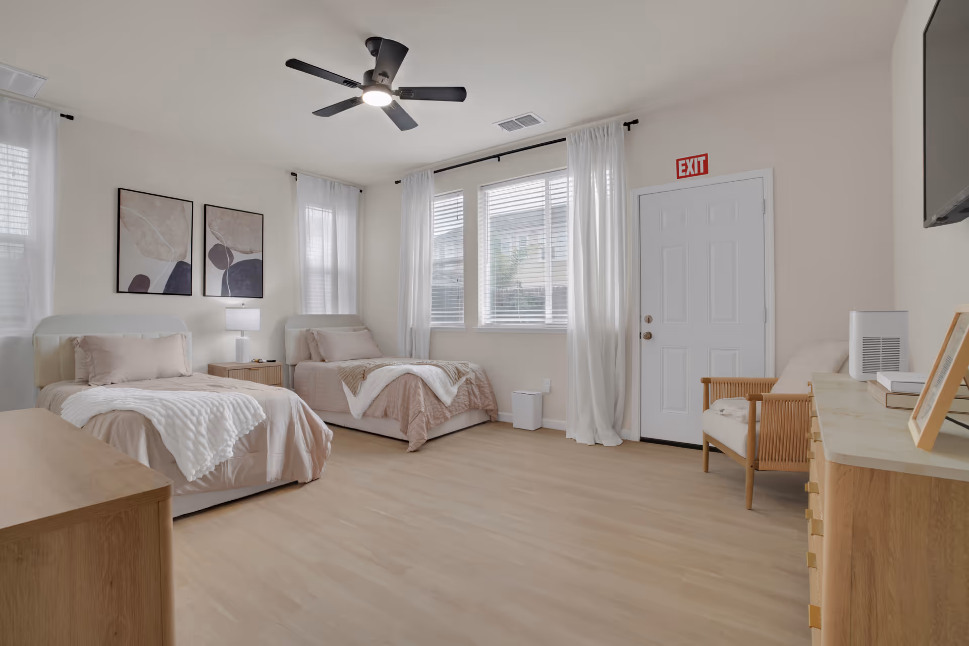 Two twin beds in a bright, minimalist senior living bedroom.