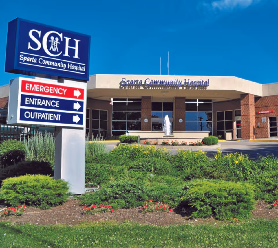 Front view of Sparta Community Hospital with sign, glass doors, and landscaped entry.
