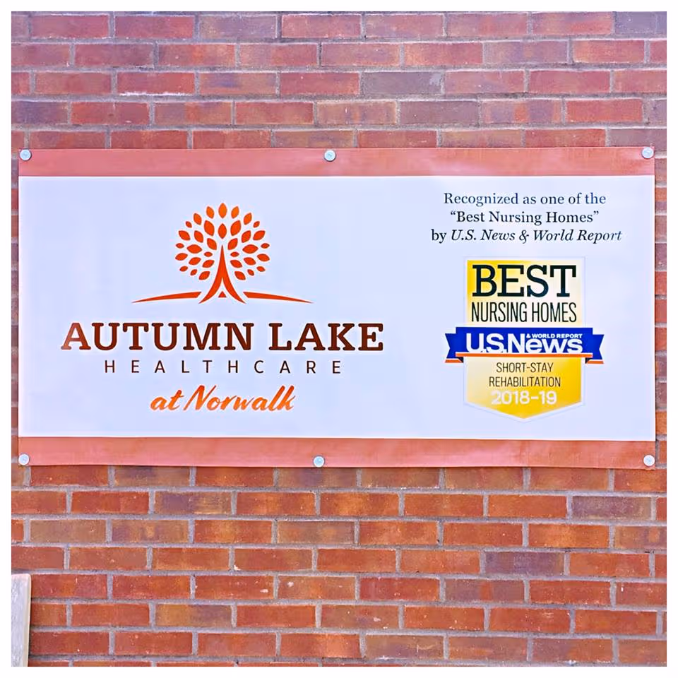 Sign on brick exterior wall reads Autumn Lake Healthcare at Norwalk.