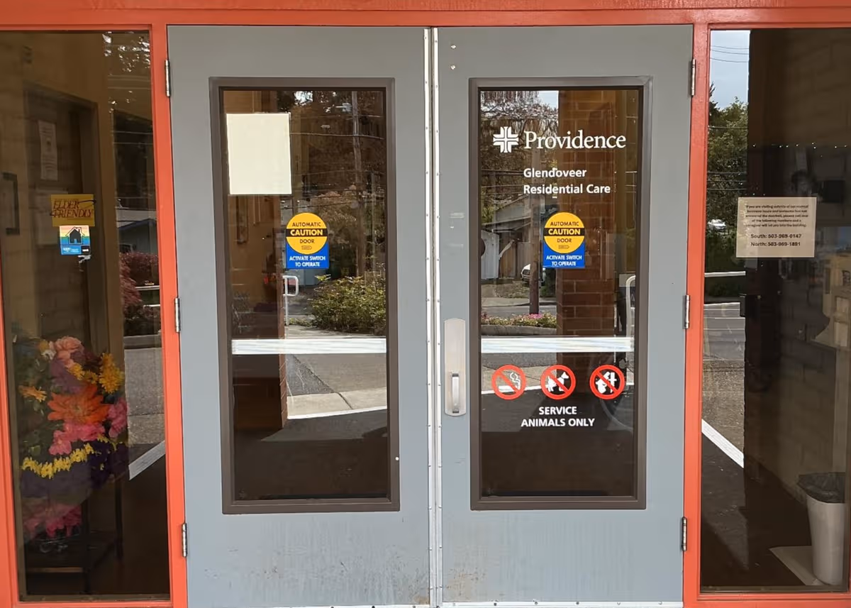 Double glass doors with Providence logo, red frame, and entry lobby visible inside.