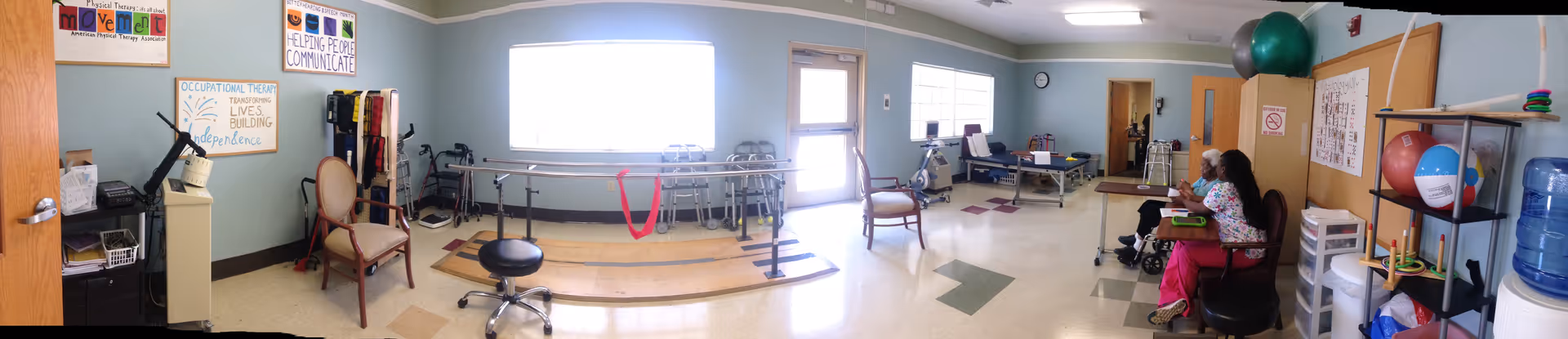 Wide interior view at Chase City Health and Rehab Center: senior rehab and activity room.