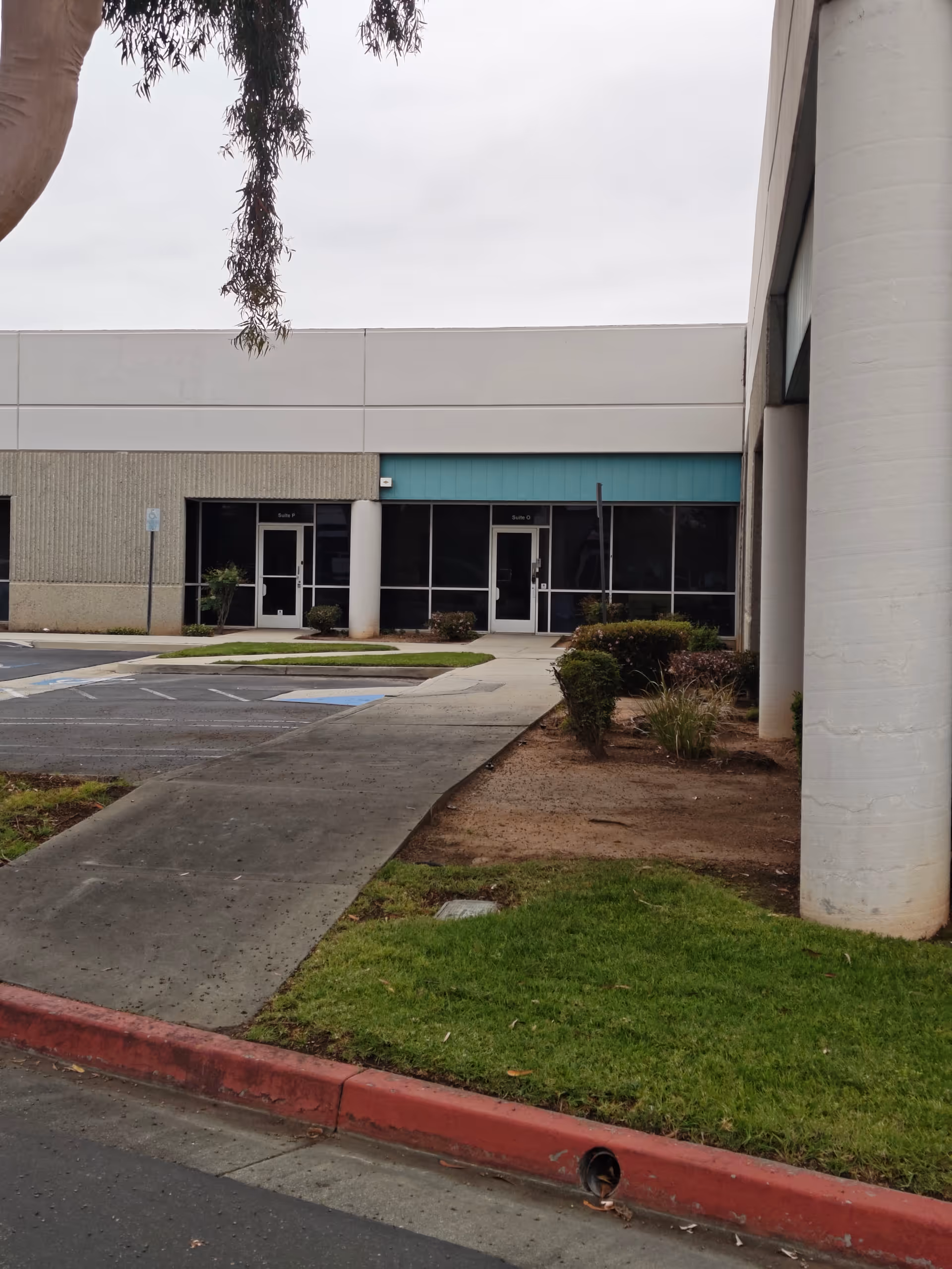Exterior view of Autism Spectrum Therapies AST facility entrance with glass doors and walkway
