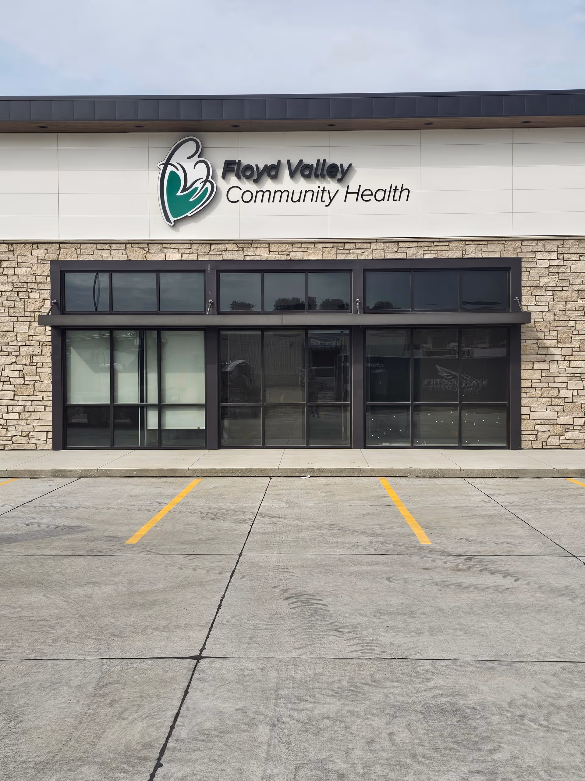 Front exterior of Floyd Valley Community Health building with large windows and a parking lot.