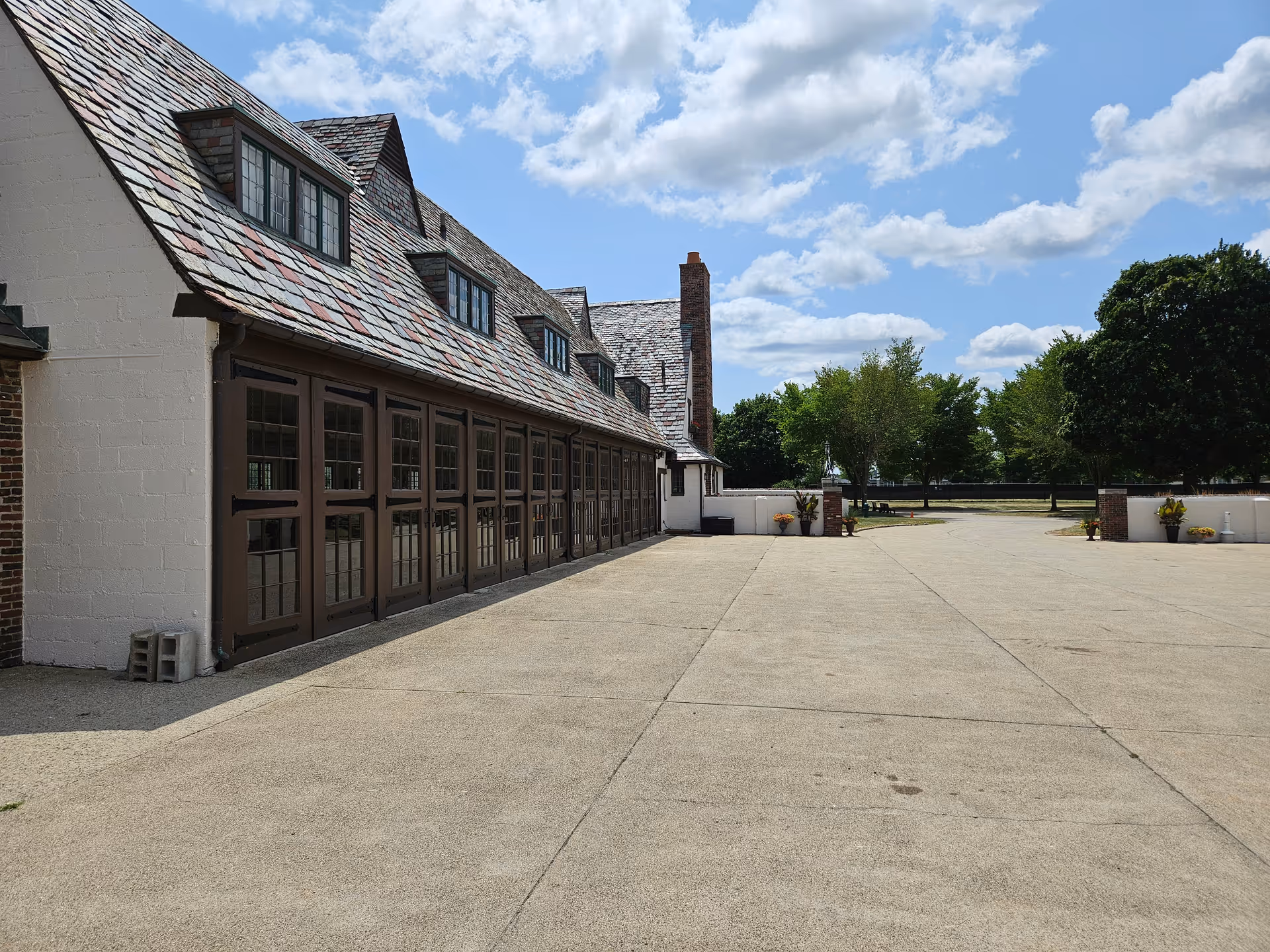 Exterior view of a senior living facility with a long row of doors and open courtyard.