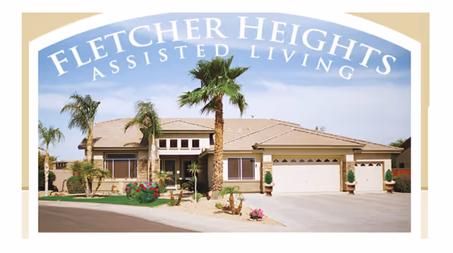 Single-story assisted living building with an arched sign, palm trees, and a two-car garage.