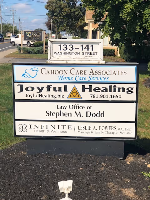 Outdoor multi-tenant signboard advertising Cahoon Care Associates and other businesses.