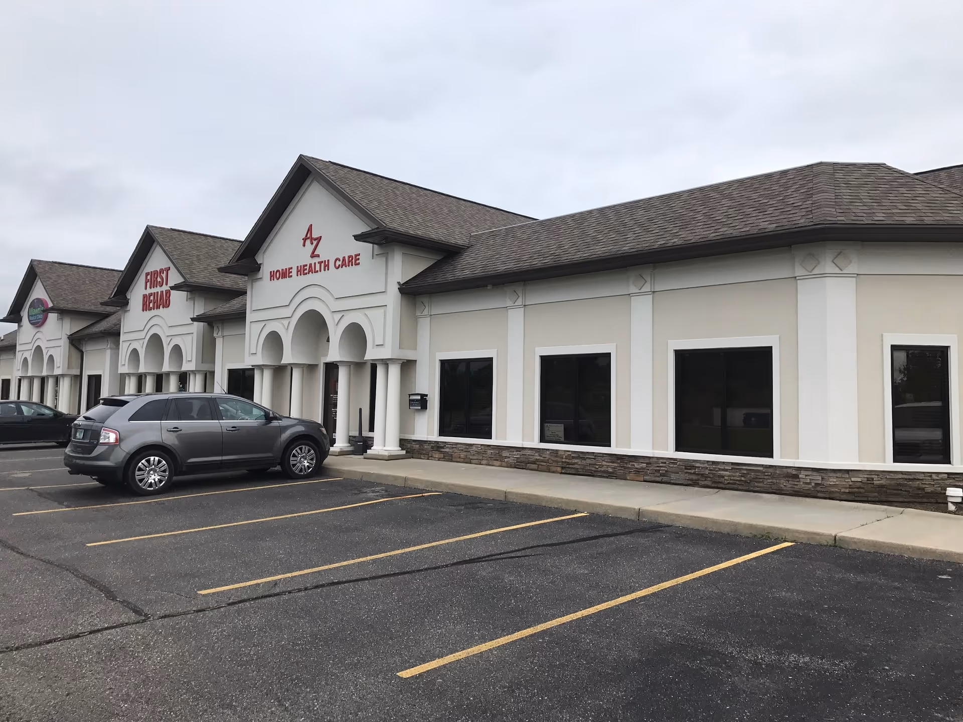 Exterior view of Az Home Health Care Inc building with parked cars in front.