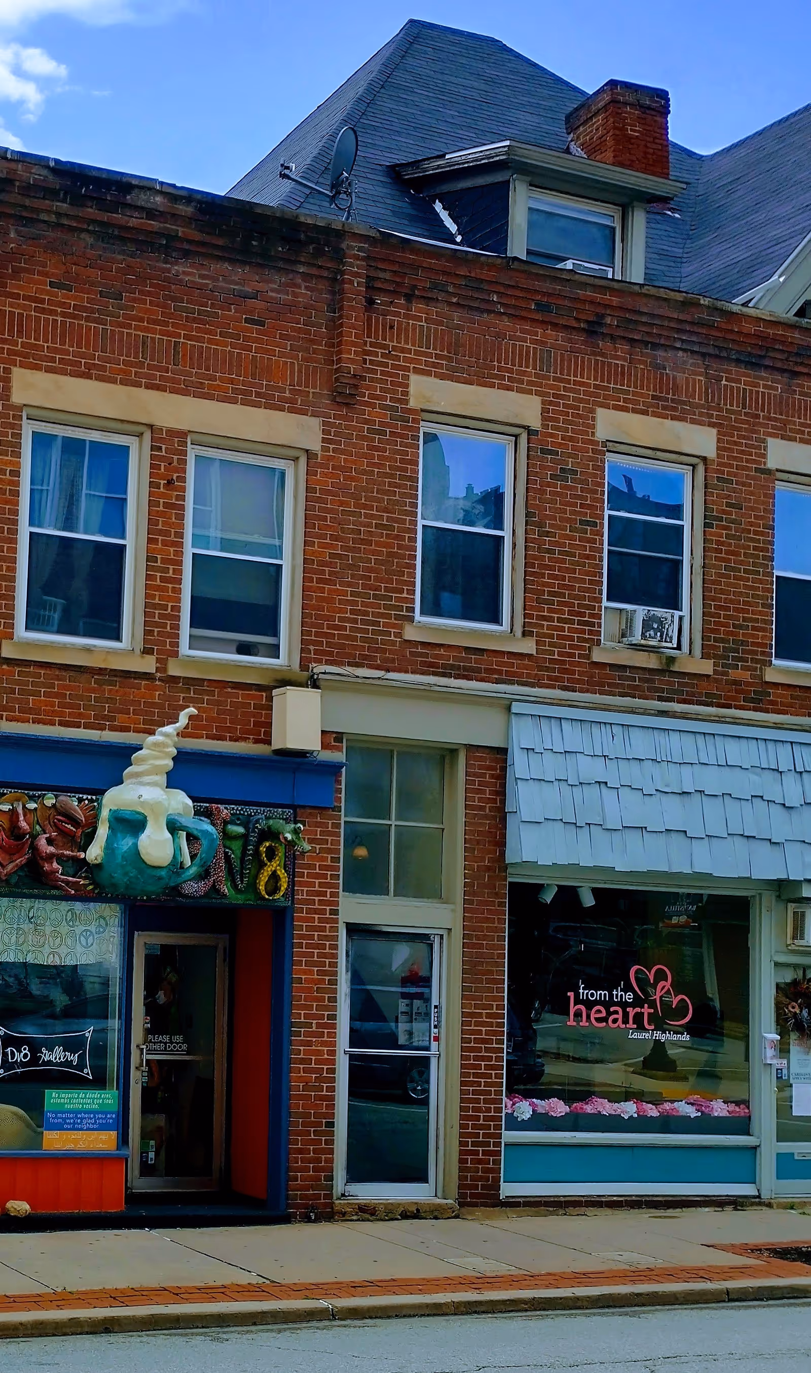 Brick building facade with From the Heart storefront sign and windows