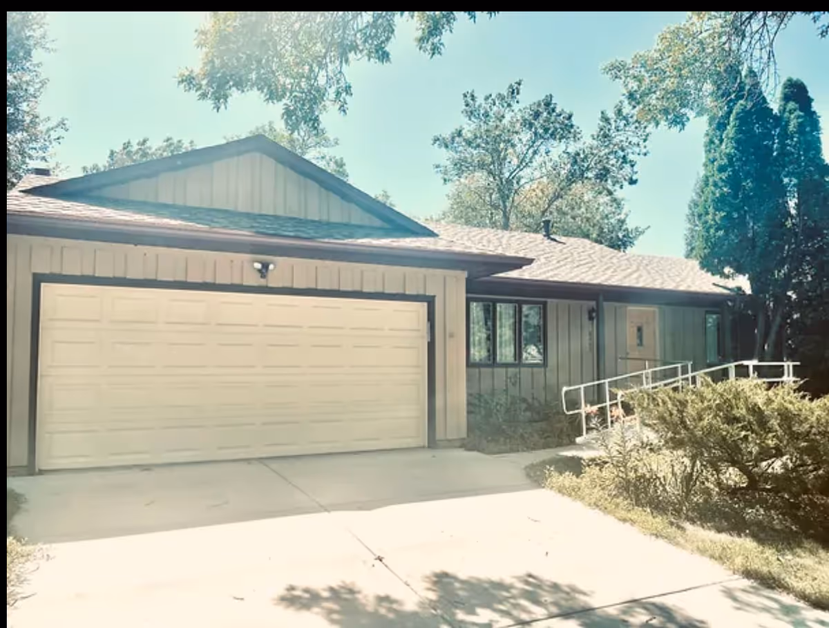 Exterior of a single-story facility with a garage and ramped entrance