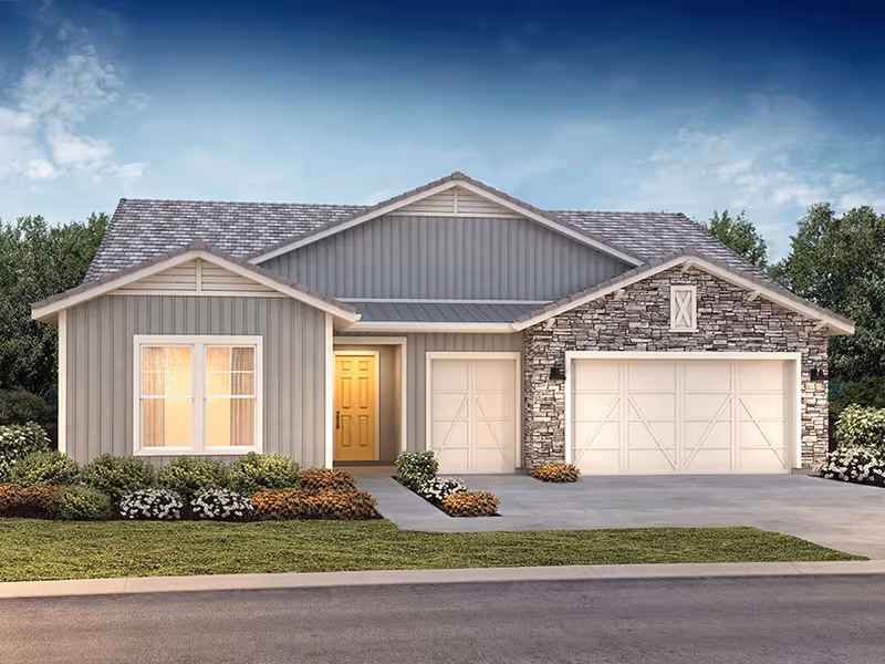 Front view of a single-story home with a two-car garage and stone accents.