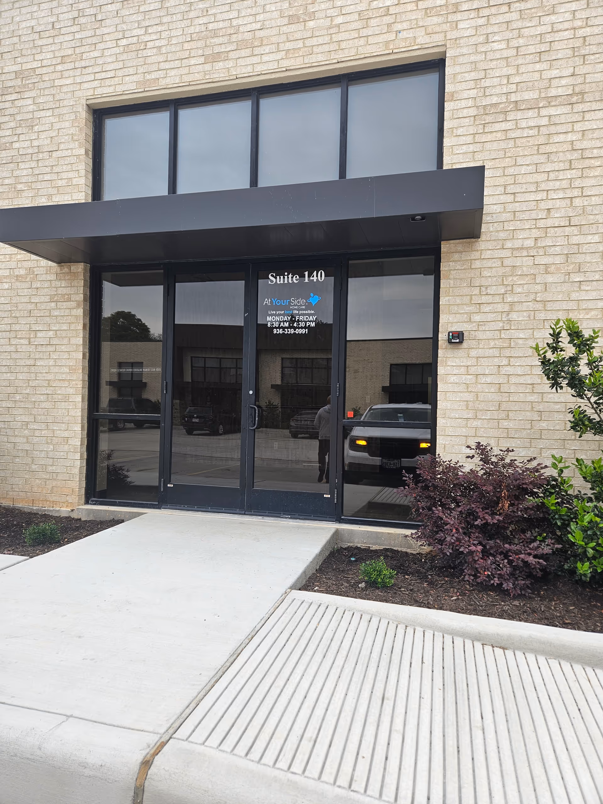 Glass door entrance to a senior care facility with signage.