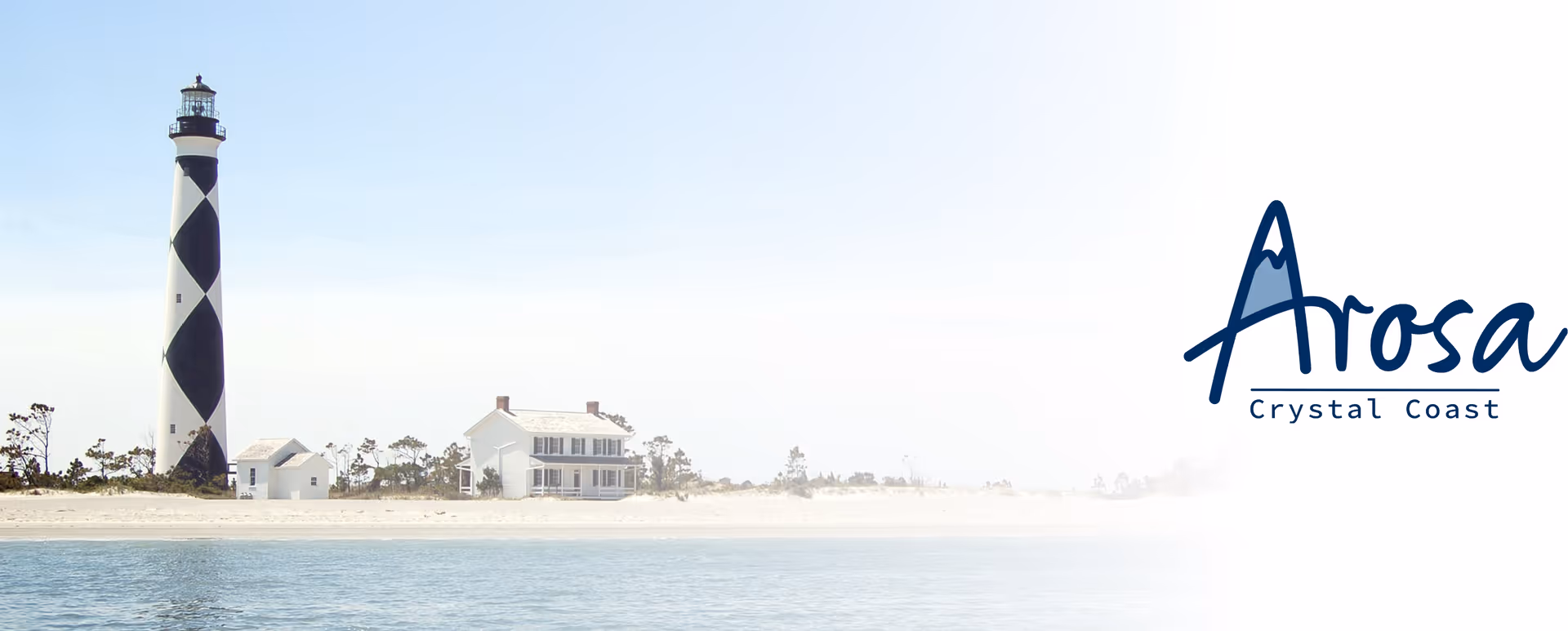 Lighthouse and beach houses along the coast with Arosa Crystal Coast logo.