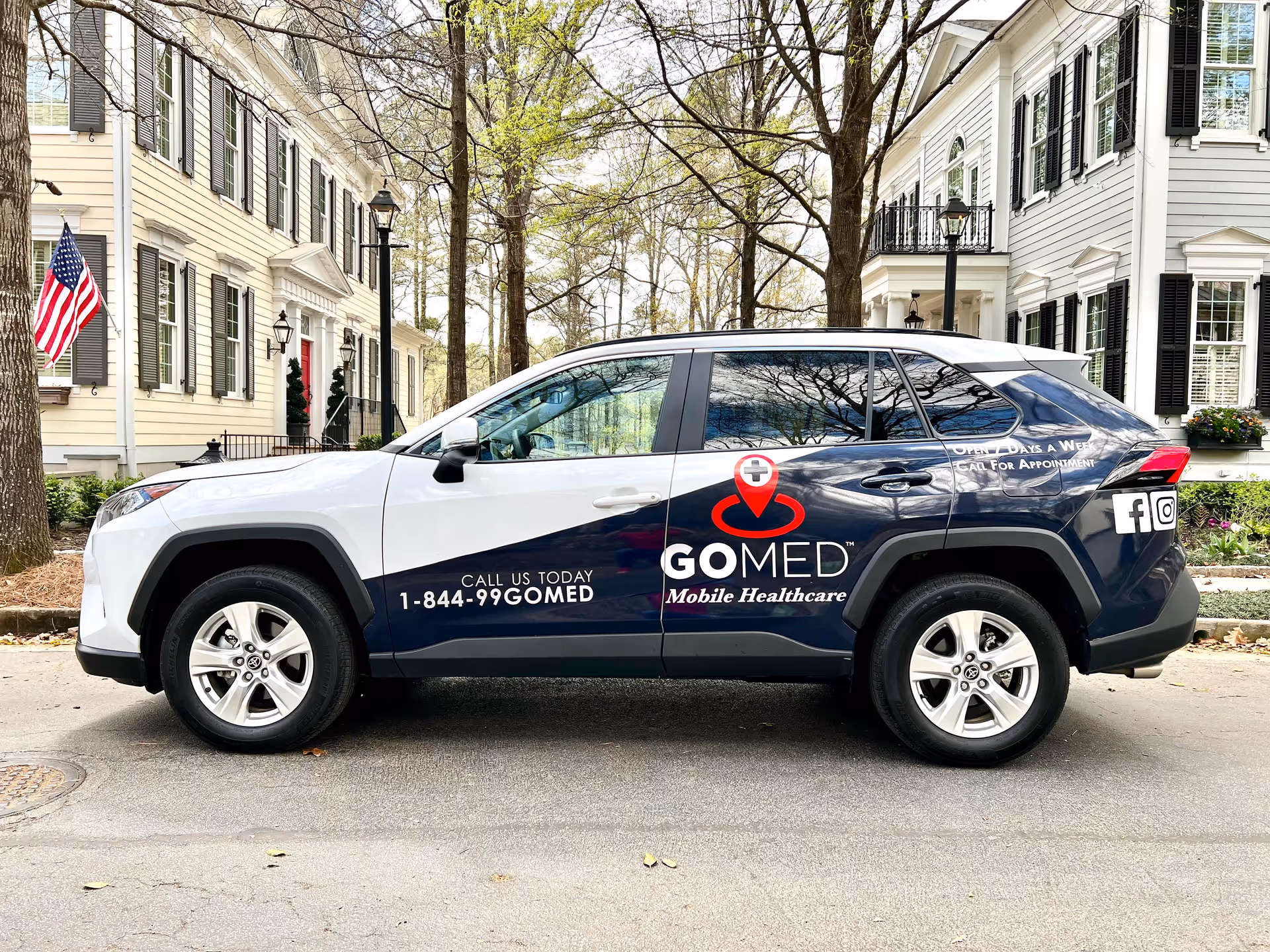 Branded GOMED Mobile Healthcare SUV parked on a residential street.