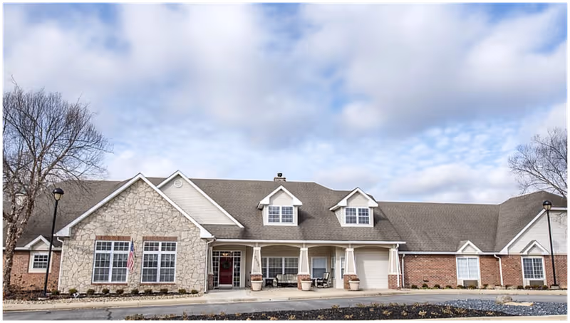 Front view of Commons at Jackson Creek senior living facility with stone facade and entrance.