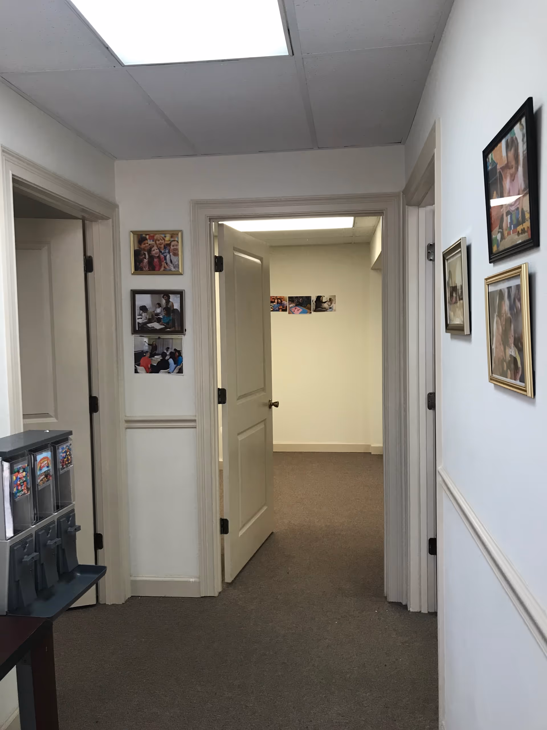 Interior hallway of a senior living facility with wall photos.