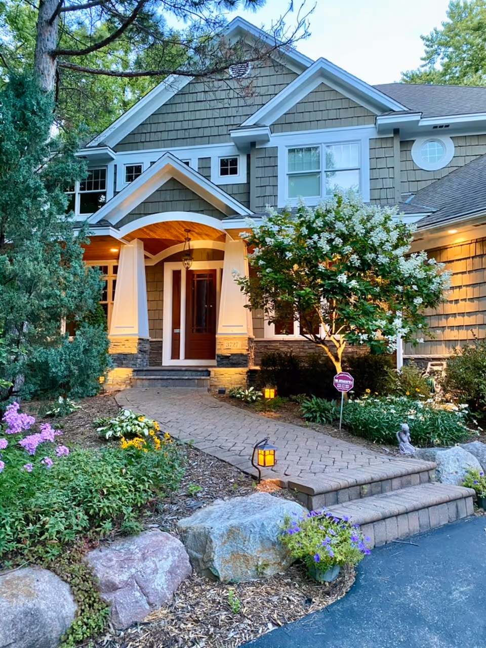 Front view of SPIRIT Care Homes entrance with landscaped walkway and garden.
