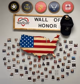 Wall of Honor display with photos around a USA map at No Place Like Home Health.