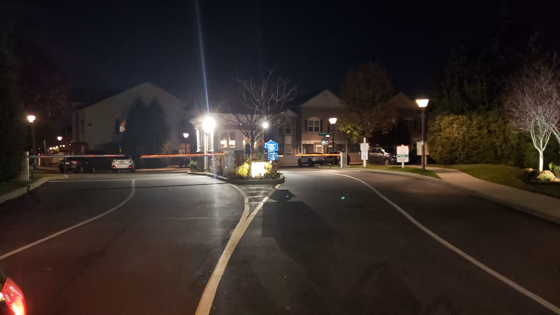 Night exterior view of Seasons at East Meadow with an illuminated entrance.