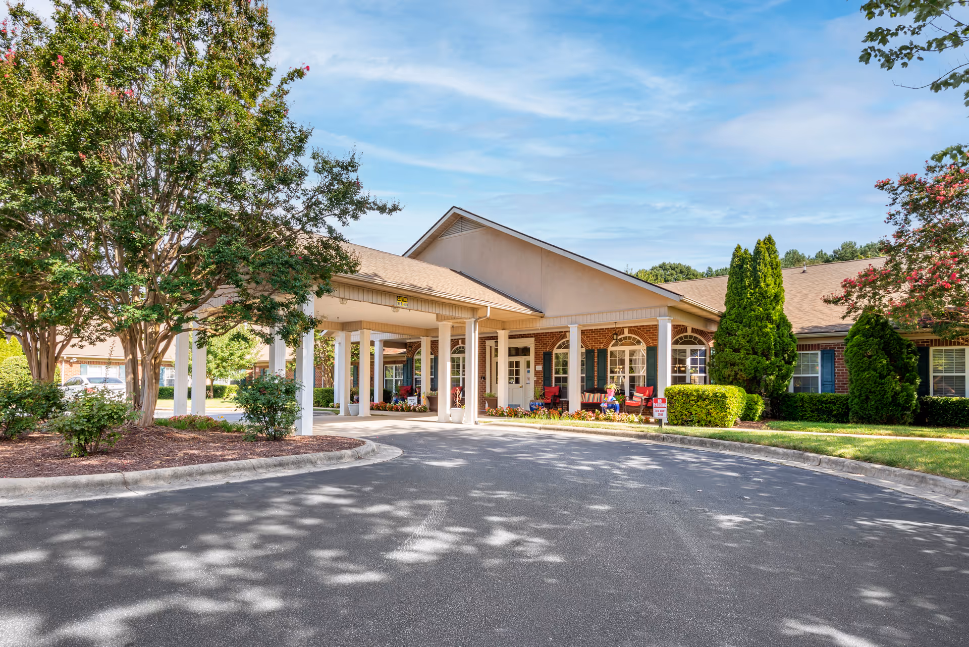 Front entrance of Brookdale Concord Parkway senior living, featuring a covered driveway and landscaping.
