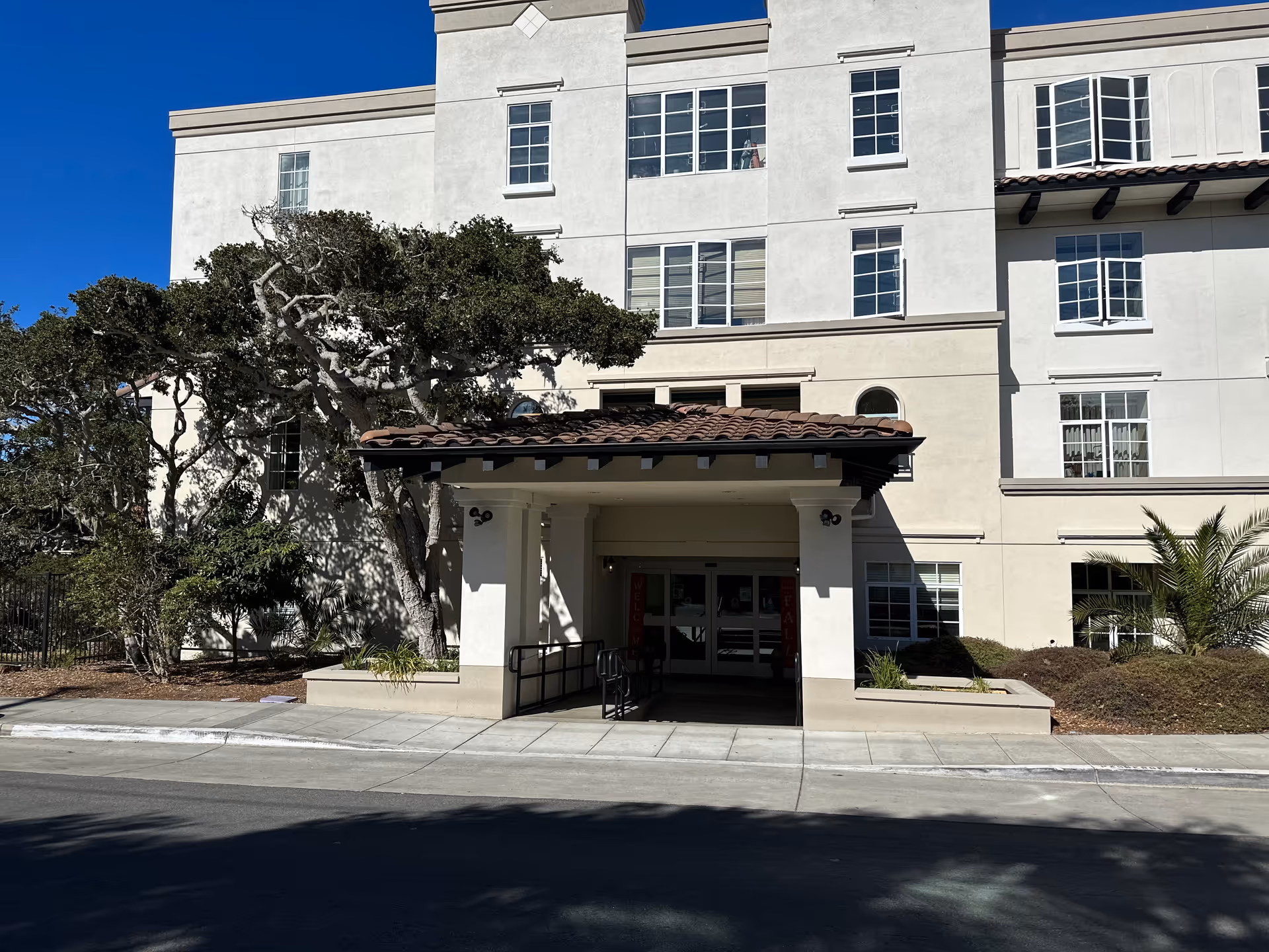 The entrance of the Forest Hill Post Acute senior living facility, featuring a covered walkway and landscaped area.