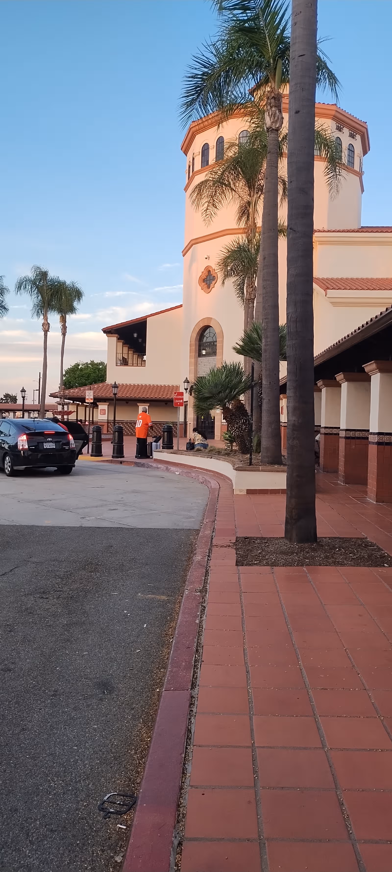 Exterior of Blessed Hope Care Home building with palm trees and parked cars.