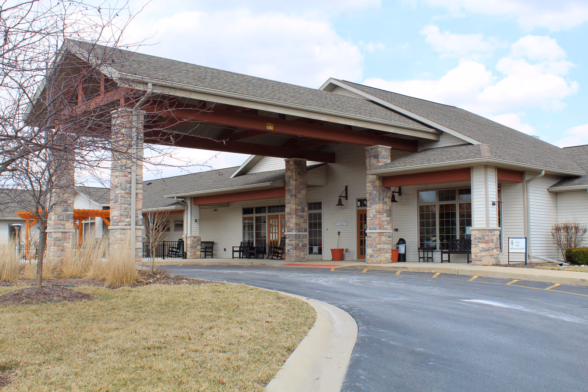 Exterior view of Lutheran Life Villages Pine Valley entrance with stone pillars and covered driveway.