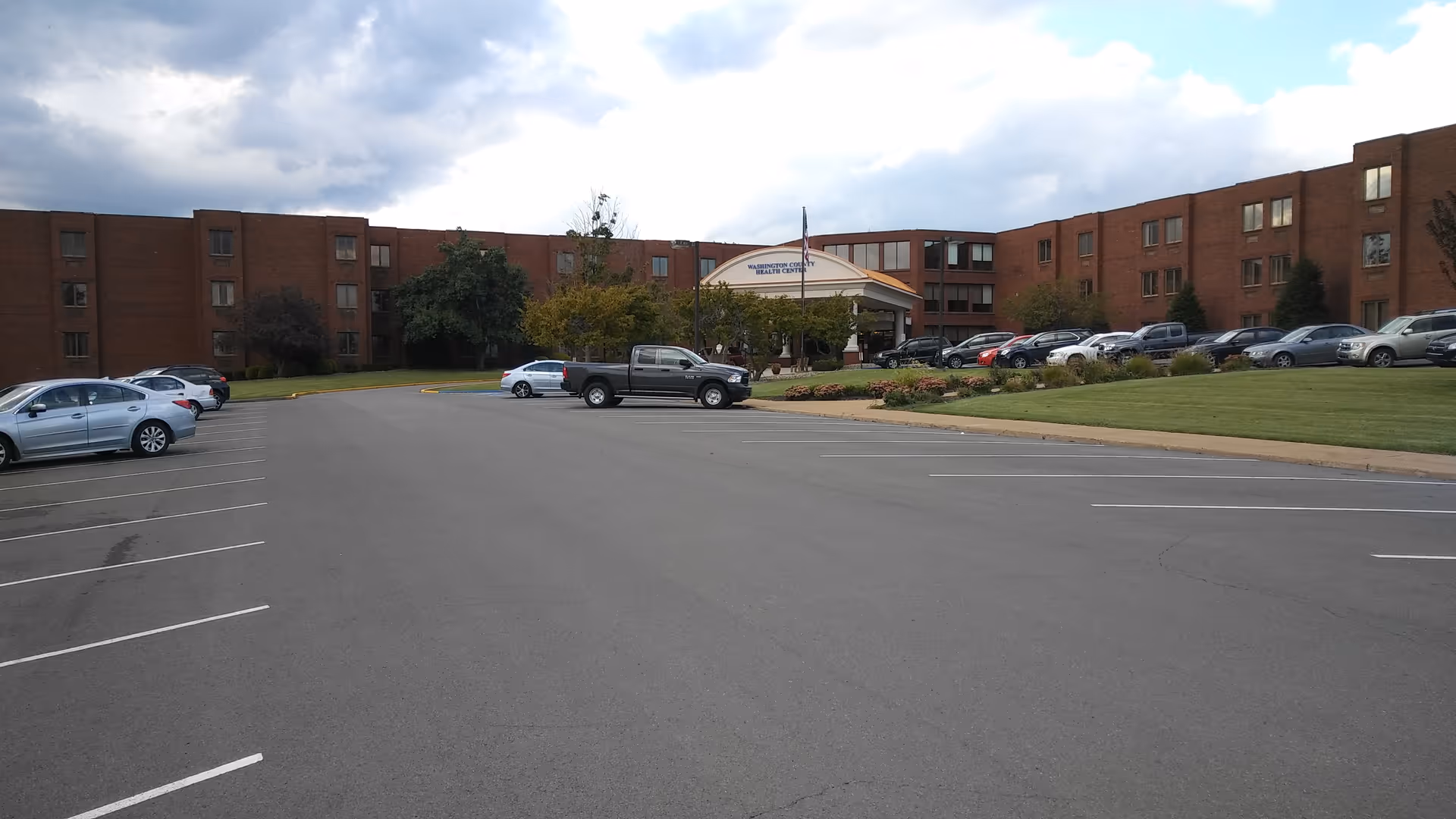 Exterior view of Washington Rehab & Nursing Center with parking lot and brick building.
