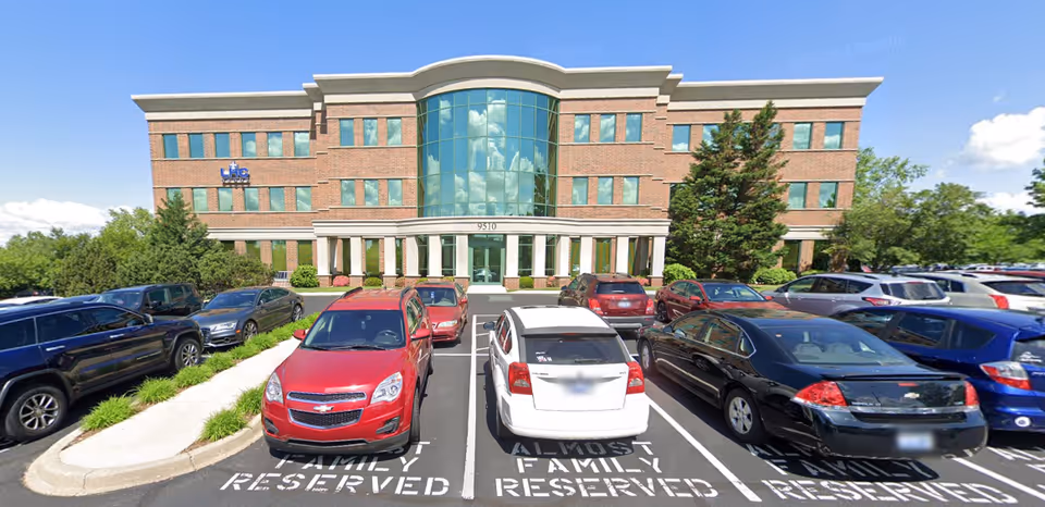 Exterior view of Norton Home Health building with glass entrance and parking lot.