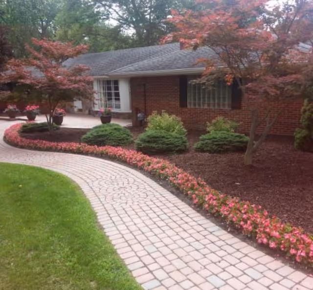 Brick, single-story facility with curved brick walkway and manicured front landscaping.