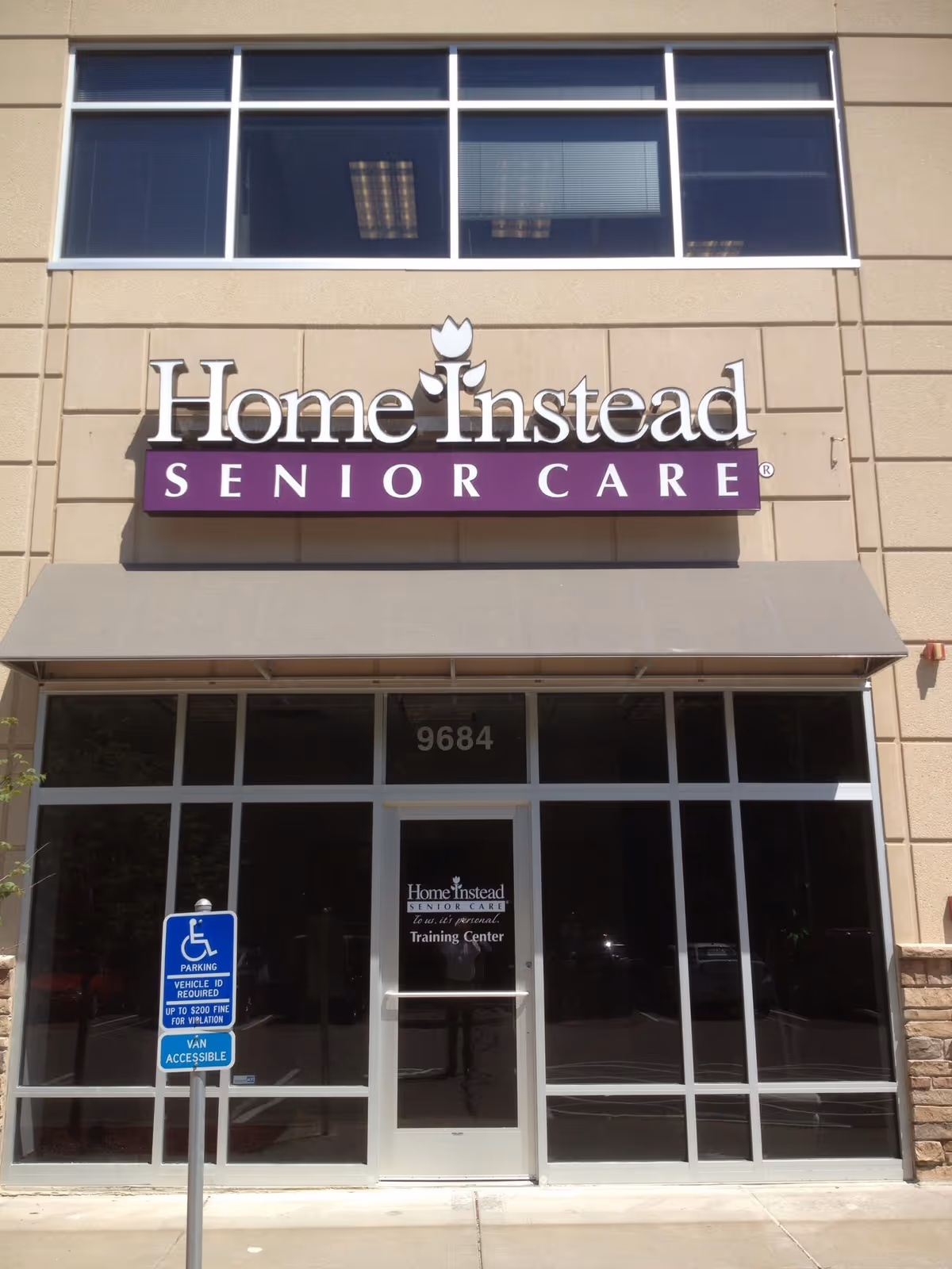 Exterior of a Home Instead Senior Care facility with a large glass entrance and signage.